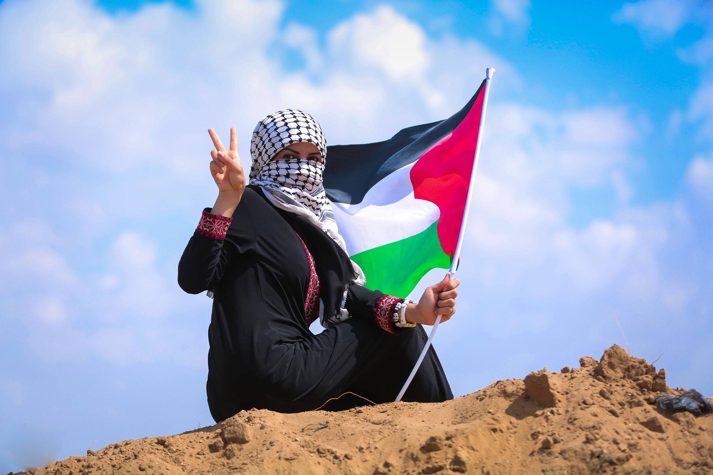 Woman Holding a Palestinian Flag 